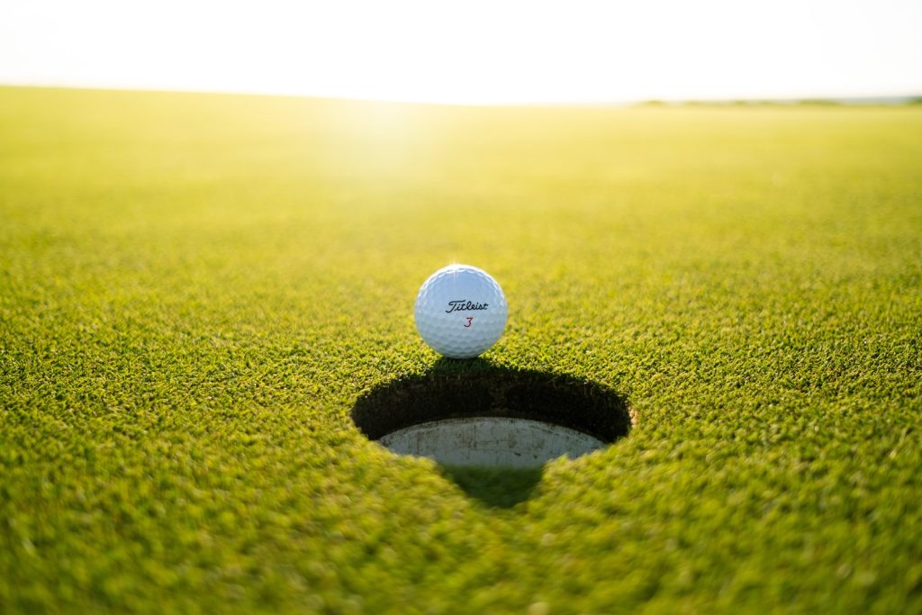 golf ball on green grass field during daytime